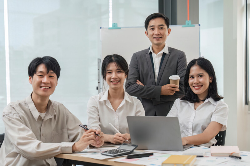 succesful business team smiling with teamwork corporate office colleague.